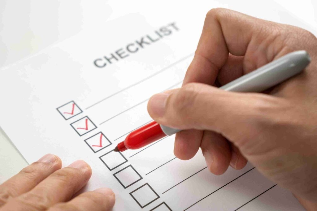 hand-with-red-marker-pen-marking-on-checklist-box